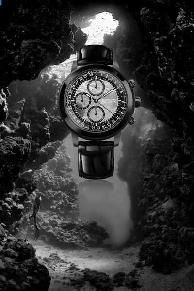 Black chronograph in front of a cave