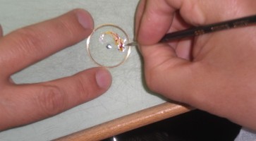 Artist painting a sapphire disk